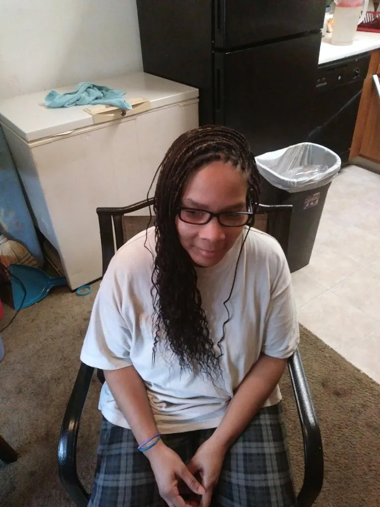 Client looking down to show long dark box braids — Box Braids