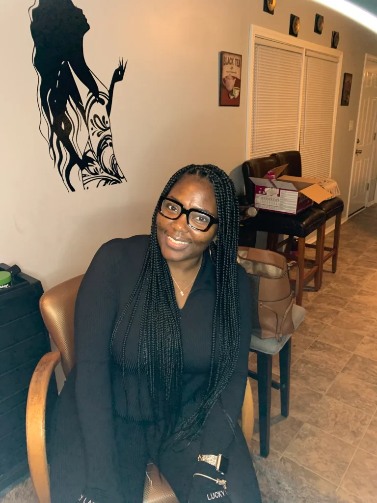 Client seated with waist-length black knotless braids — Knotless Braids